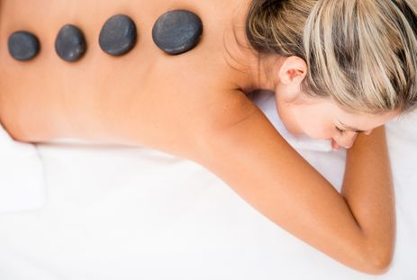 Woman getting a relaxing massage with hot stones-1