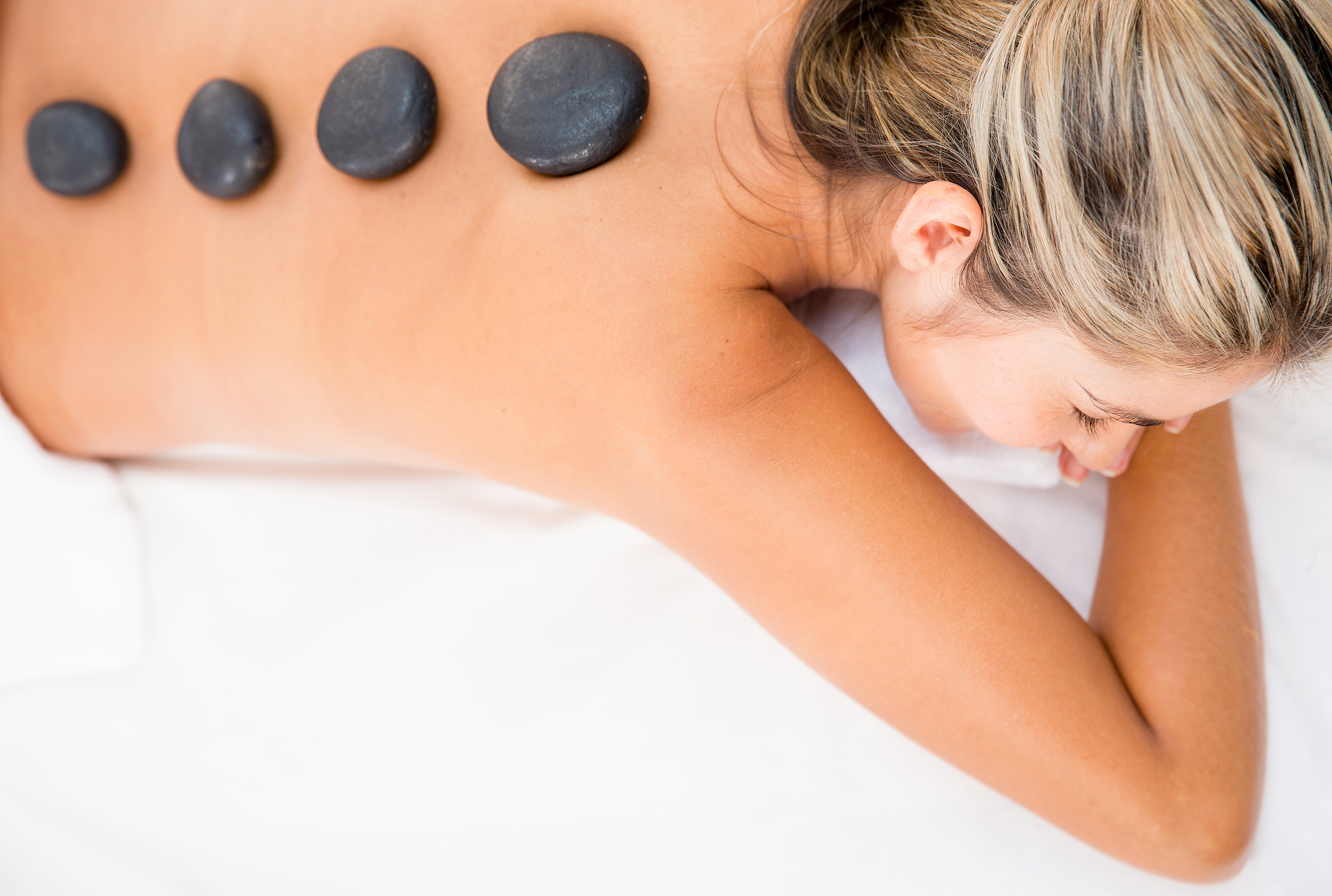 Woman getting a relaxing massage with hot stones-1